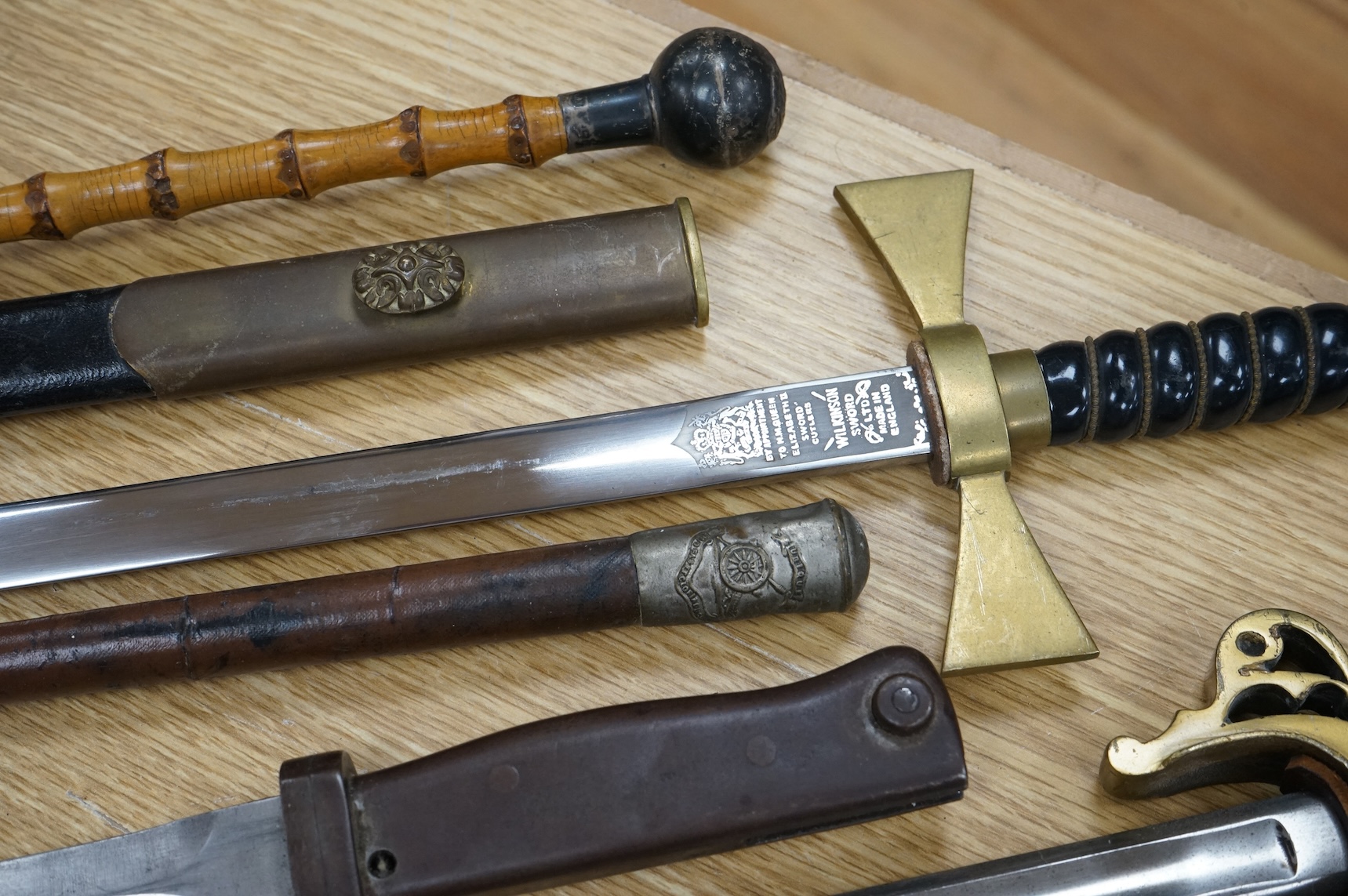 An Imperial German presentation infantry officer’s sword dated 1919/20, another similar with plain blade and brass stirrup hilt, another similar, plain in steel scabbard, a Wilkinson masonic sword probably circa 1950, a